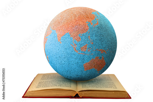 Earth globe on an open book showing Asia and Australia: study and learning concept. The open book symbolizes reading, study and global learning.