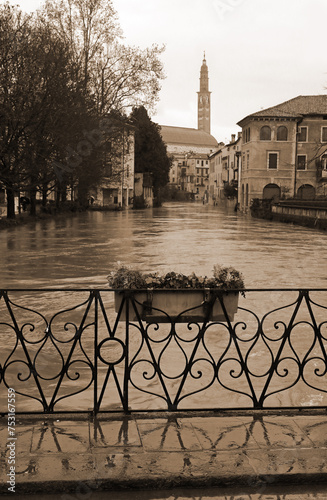 FURO Bridge and under the swollen RETRONE River during the flood in the city of Vicenza in Italy with vintage toned