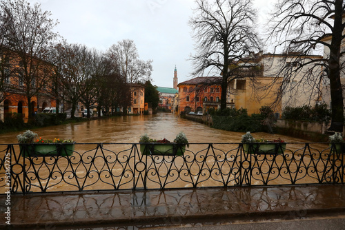 Flowerpots on the FURO Bridge and under the swollen RETRONE River during the flood in the city of Vicenza in Italy due to climate change