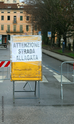 warning sign with text ATTENZIONE STRADA ALLAGATA in italian language that means CAUTION FLOODED ROAD photo