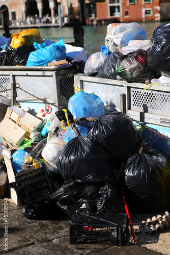 waste garbage bags in an overloaded dumpster in the city photo