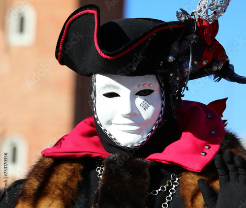 Man disguised in mask with unrecognizable face during the Venice Carnival in St Mark Square photo