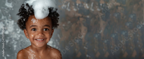 banner copyspace Little smiling african American baby boy with big soap foam on head in hair on solid grey background  Kids hygiene  Shampoo  hair treatment and soap for children  childs bathing time