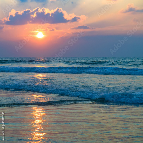 Bright sunrise over the tropical sea. Vertical photo