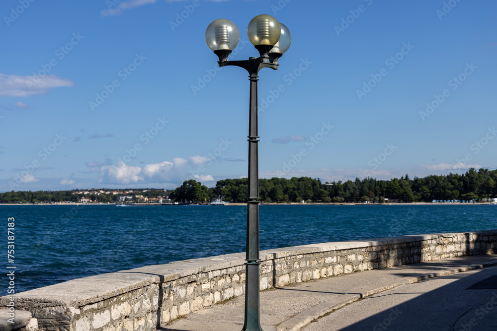 Picturesque promenade along the sea by city wall, Porec, Croatia, Istria