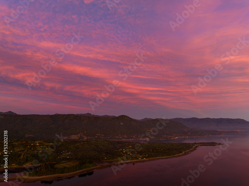 aerial view of beautiful sky with sunset colors and mountains with native forest in the background
