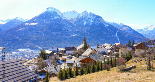 Skyline of Puy-Saint-Pierre in front of snow-capped mountains - Hillside Alpine village located above Briançon in the Hautes Alpes department of the French Alps, France