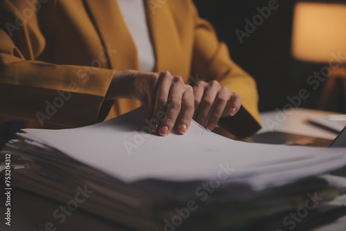 Business woman using calculator for do math finance on wooden desk in office and business working background, tax, accounting, statistics and analytic research concept © Phanphen