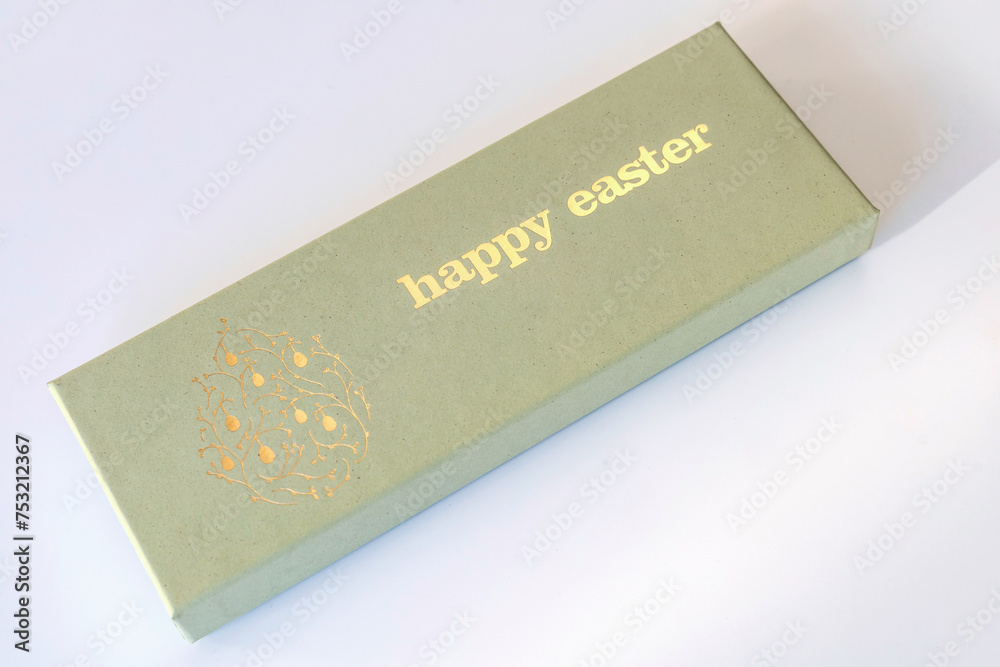 A box of chocolate eggs with the inscription in English Happy Easter. Easter concept. A box of chocolate eggs with the inscription in English Happy Easter. Easter concept.