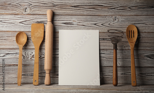 White card and Set of wooden eco kitchen utensils on boards. photo