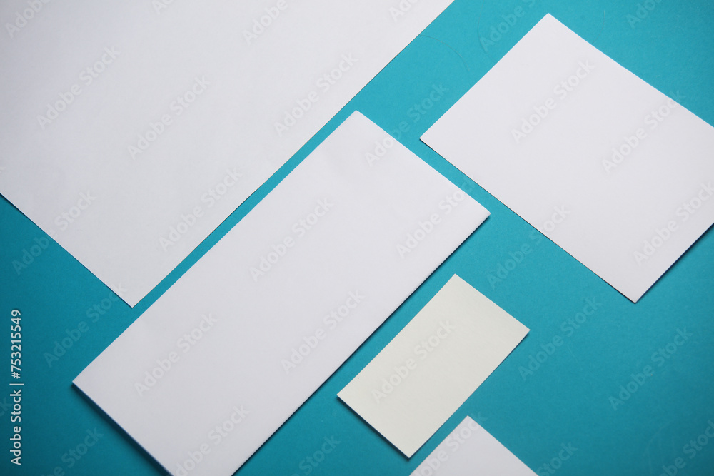 Mockup for design of white blank sheets of paper of different sizes and shapes, cards, envelope on blue background. Corporate identification. Creative layout Mockup for design of white blank sheets of paper of different sizes and shapes, cards, envelope on blue background. Corporate identification. Creative layout