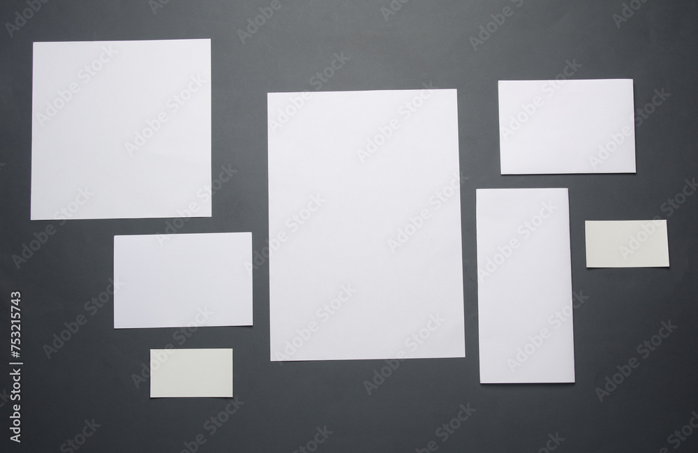 Mockup for design of white blank sheets of paper of different sizes and shapes, cards on dark gray background. Corporate identification. Creative layout Mockup for design of white blank sheets of paper of different sizes and shapes, cards on dark gray background. Corporate identification. Creative layout