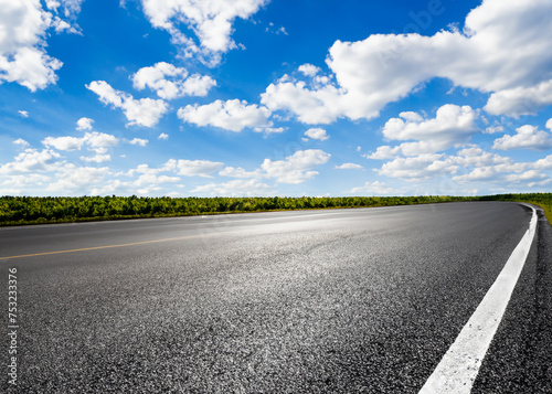 abstract empty road in summer, blue sky, white clouds, highway or speedway in rural countryside created with generative ai technology photo