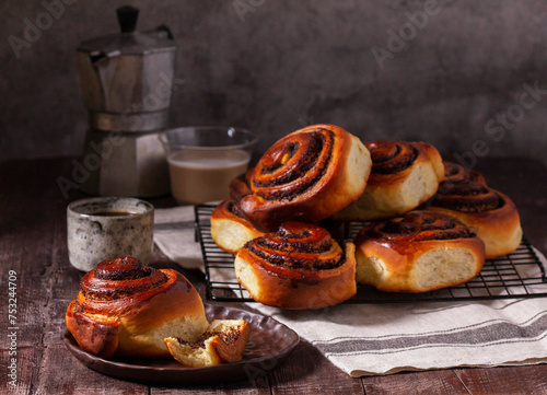 Obraz na płótnie Yeast dough cinnabons with poppy seeds, raisins and candied fruits, served with coffee. Rustic style. w salonie