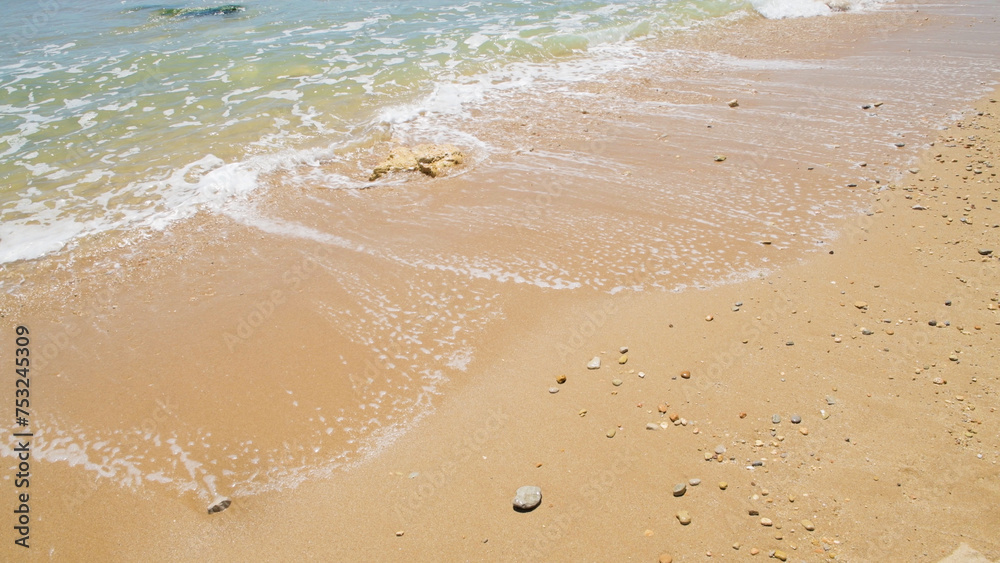 Waves crashing on the sandy beach Waves crashing on the sandy beach