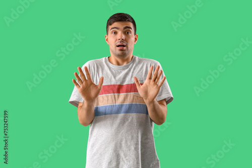 Afraid young man on green b...