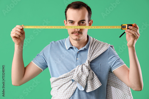 Young man with tape measure...