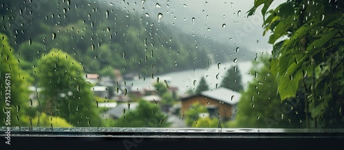 Tranquil Rainy Day Scene with Water Droplets on a Window and Lush Trees Outside