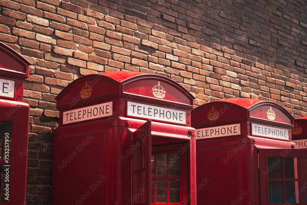 Quintessential Row of British Red Telephone Boxes by Brick Wall FaÃ§ade