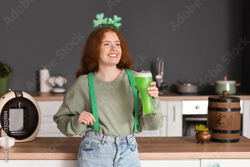 Young woman with beer in ki...