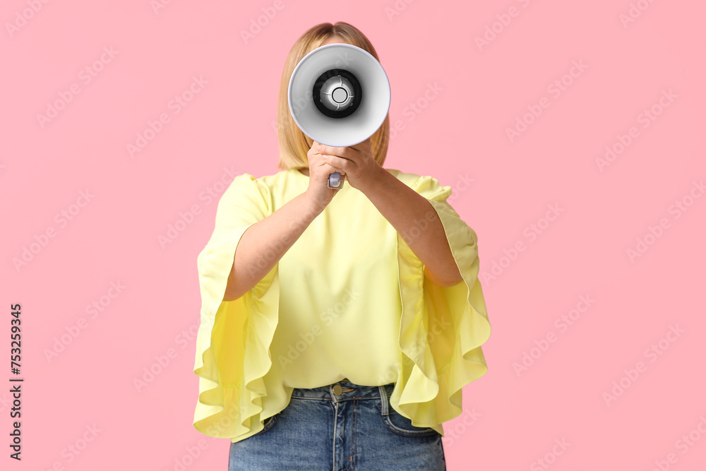 Fototapeta premium Mature woman with megaphone on pink background