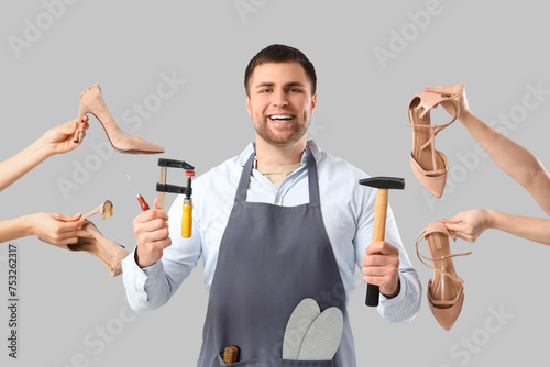 Male shoemaker with tools a...