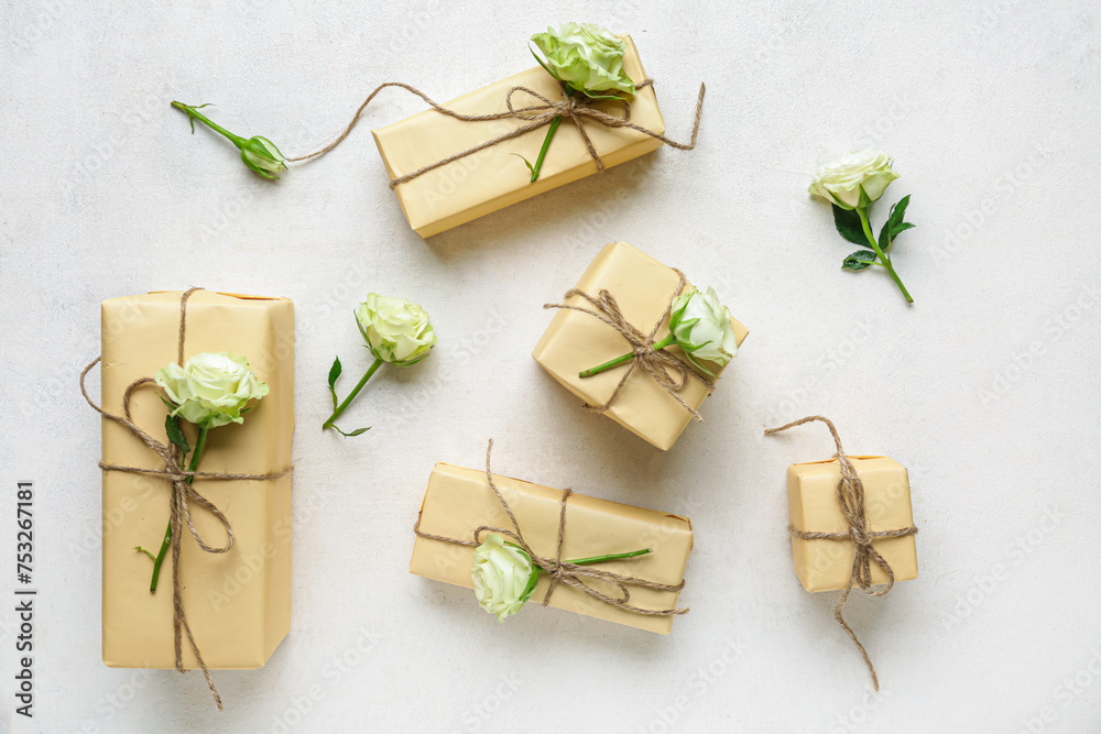 Many gift boxes with beautiful roses on white background. International Women's Day Many gift boxes with beautiful roses on white background. International Women's Day