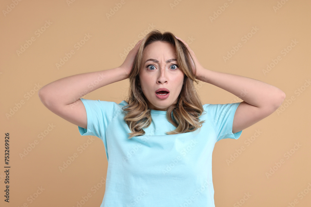Portrait of surprised woman on beige background Portrait of surprised woman on beige background