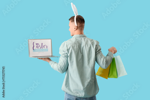 Young man in bunny ears wit...