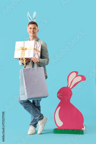 Young man in bunny ears wit...