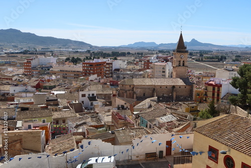 Villena, Alicante, Spain, March 5, 2024: Houses around the Church of Santa Maria with the mountains in the background. Villena, Alicante, Spain photo
