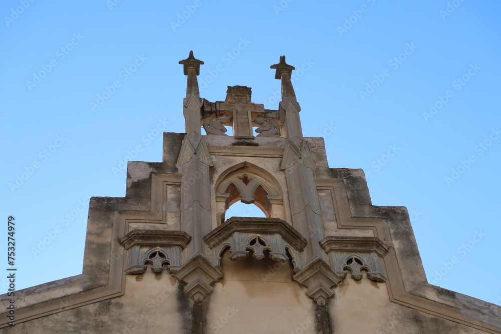 Villena, Alicante, Spain, March 5, 2024: Bell tower on the facade of a church in the Plaza de las Malvas in Villena, Alicante, Spain