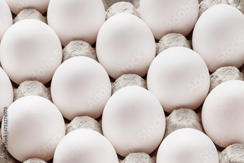 Carton of fresh brown and white eggs photo