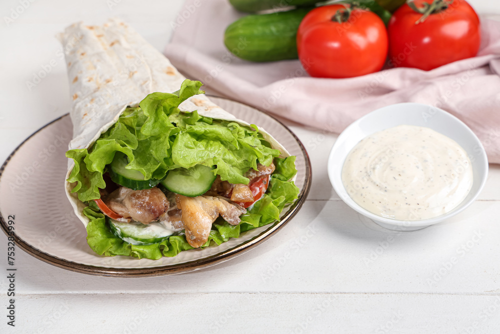Plate with tasty doner kebab and sauce on white wooden background Plate with tasty doner kebab and sauce on white wooden background