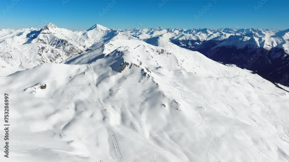 The ski area on the Motta Naluns mountain in Scuol, Switzerland on a sunny winter day. The ski area on the Motta Naluns mountain in Scuol, Switzerland on a sunny winter day.