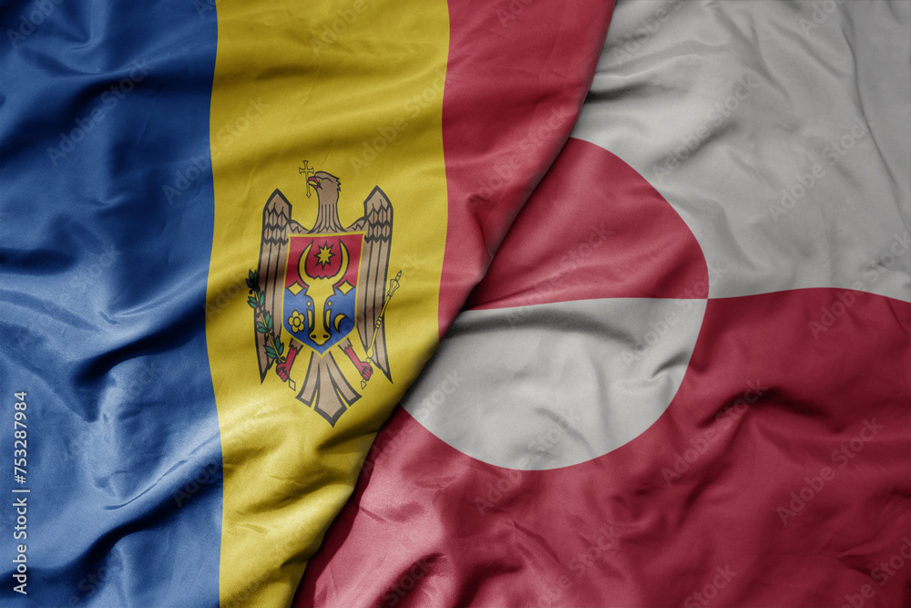 Fototapeta premium big waving national colorful flag of greenland and national flag of moldova .