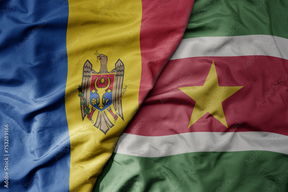 big waving national colorful flag of suriname and national flag of moldova . big waving national colorful flag of suriname and national flag of moldova .