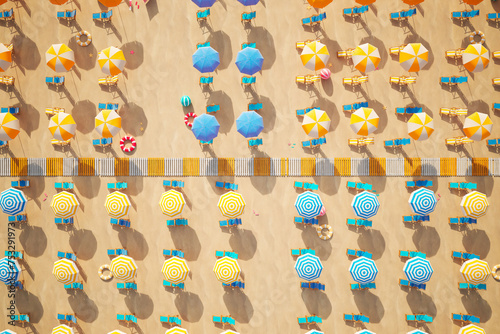 Vibrant Aerial View of Busy Beach with Colorful Umbrellas and Sun Loungers photo