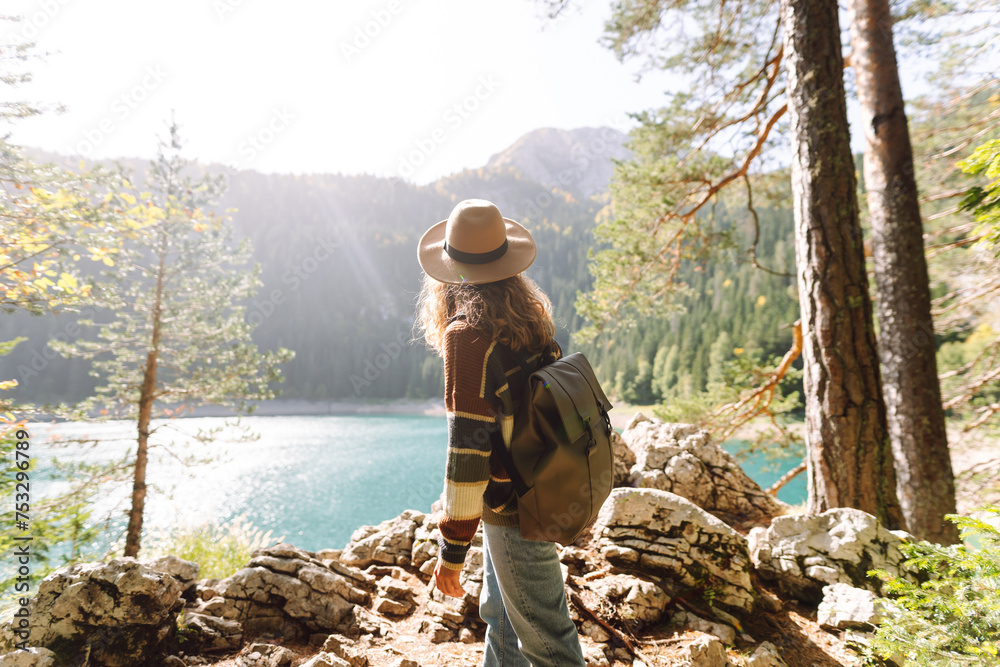 Young woman enjoy mountains and lake. Lifestyle, adventure, nature, active life.