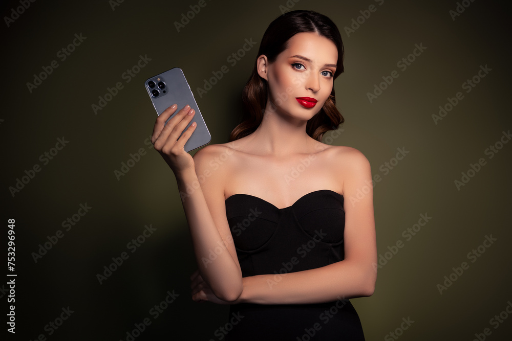 Photo of stunning luxurious lady wear elegant black dress advertise modern iphone isolated on khaki color background Photo of stunning luxurious lady wear elegant black dress advertise modern iphone isolated on khaki color background