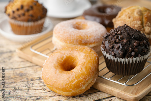 фотографія glazed donuts with coffee and muffins