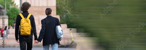 Young couple walking holding hands