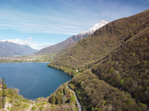 Swiss mountain lake in summer surrounded by lush green meadows and alpine peaks. photo