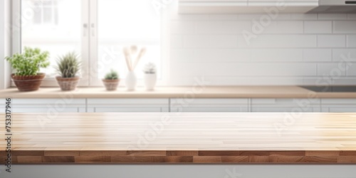 Blurred white kitchen with wooden oak countertop, ready for product or layout display. © Vusal