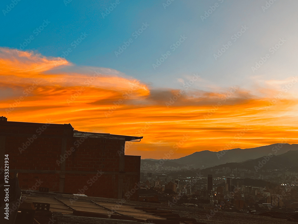 Beautiful sunset with orange sky and huge cloud seen from the Manrique neighborhood. Medellin, Antioquia, Colombia.