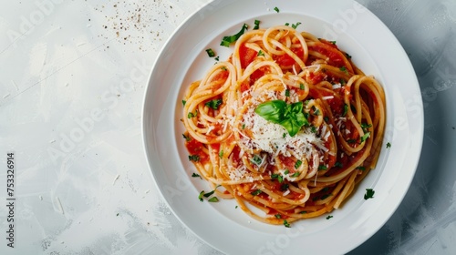 Spaghetti in tomato sauce with cheese on a white plate on a light background. Flat lay