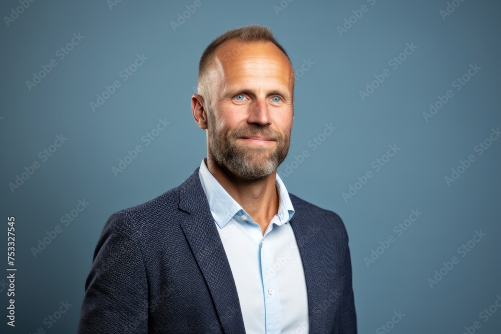 Handsome middle aged man with beard and mustache over blue background. Handsome middle aged man with beard and mustache over blue background.