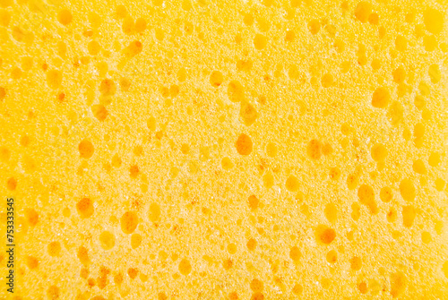 Yellow porous cleaning sponge texture or background photo