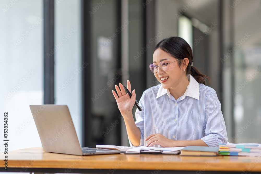 Asian Businesswoman Using laptop computer and working at office with calculator document on desk, doing planning analyzing the financial report, business plan investment, finance analysis concept.
Asian Businesswoman Using laptop computer and working at office with calculator document on desk, doing planning analyzing the financial report, business plan investment, finance analysis concept.