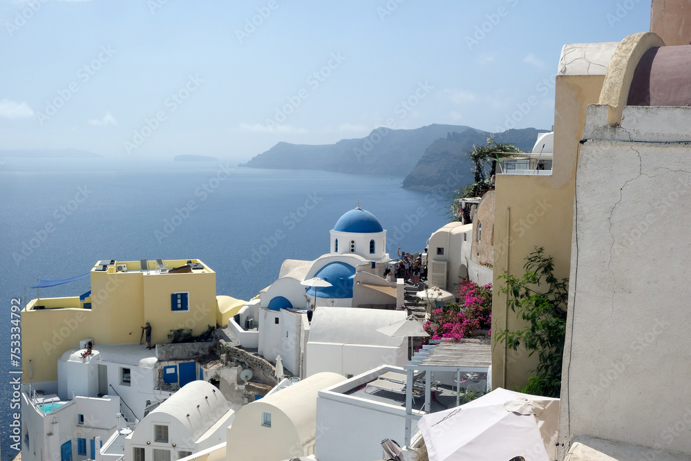 Aerial view of Oia town on the rocky shores of Santorini island - obrazy, fototapety, plakaty 
